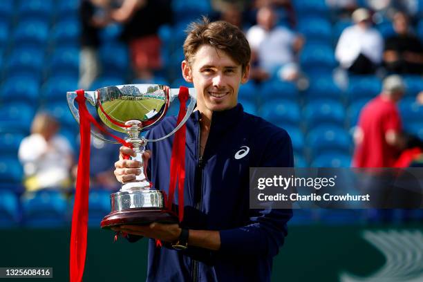 Alex De Minaur of Australia poses for a photo with the trophy after winning the mens singles final against Lorenzo Sonego of Italy during day 8 of...