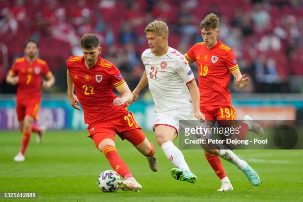 Chris Mepham of Wales is challenged by Andreas Cornelius of Denmark during the UEFA Euro 2020 Championship Round of 16 match between Wales and...