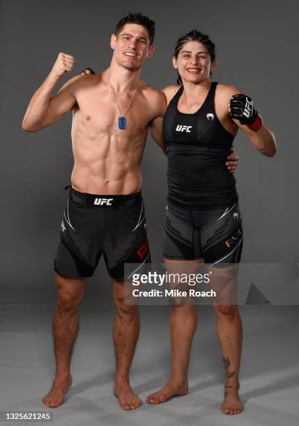 Julia Avila and Charles Rosa pose for a portrait backstage after their victories during the UFC Fight Night event at UFC APEX on June 26, 2021 in Las...