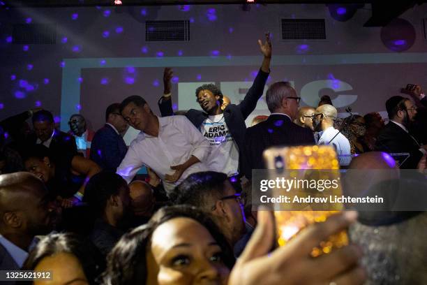Supporters of mayoral candidate Eric Adams celebrate his electoral victory in a primary runoff inside an overcrowded bar on June 22, 2021in the...
