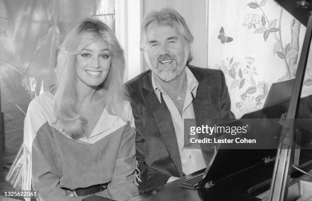 American actress and singer Susan Anton American singer, songwriter, musician, actor, record producer, and entrepreneur Kenny Rogers pose for a...