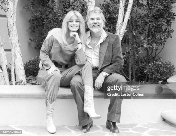 American actress and singer Susan Anton American singer, songwriter, musician, actor, record producer, and entrepreneur Kenny Rogers pose for a...