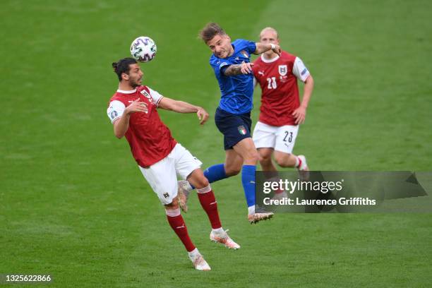 Aleksandar Dragovic of Austria wins a header whilst under pressure from Ciro Immobile of Italy during the UEFA Euro 2020 Championship Round of 16...