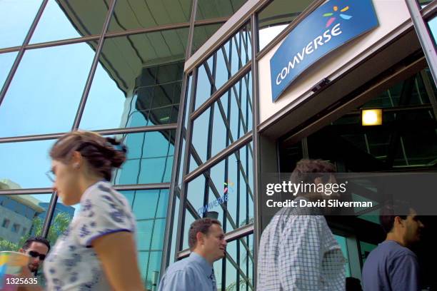 Comverse workers pass under the company logo at the entrance to Comverse''s headquarters July 12, 2001 in Tel Aviv, Israel. Comverse, the world''s...