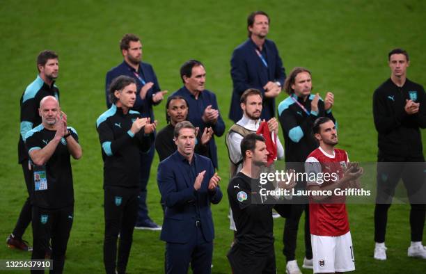 Franco Foda, Head Coach of Austria, Daniel Bachmann and Alessandro Schoepf of Austria applaud the fans after the UEFA Euro 2020 Championship Round of...