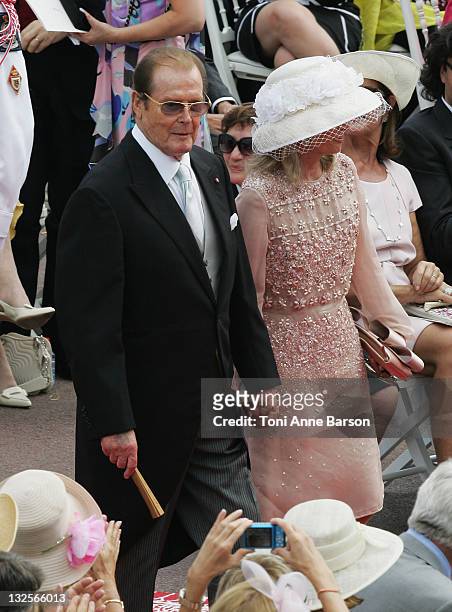 Roger Moore and Kristina Tholstrup attend the religious ceremony of the Royal Wedding of Prince Albert II of Monaco to Princess Charlene of Monaco at...