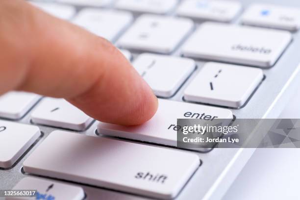close-up of hand typing computer keyboard - duwen stockfoto's en -beelden