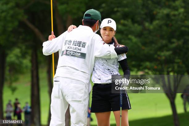 Erika Kikuchi of Japan celebrates with her caddie after winning the tournament on the 18th green during the final round of the Earth Mondamin Cup at...