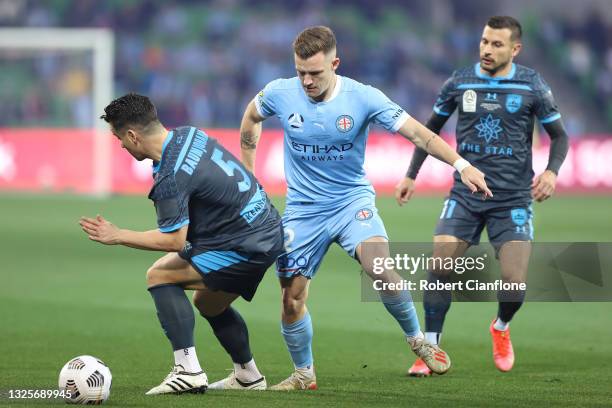 Scott Galloway of Melbourne City is challenged by Alex Baumjohann of Sydney FC during the A-League Grand Final match between Melbourne City and...