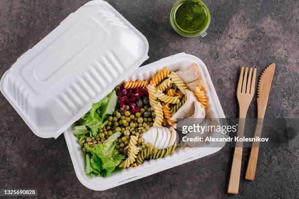 pasta bowl in eco natural paper box. healthy salad with turkey, lettuce, egg, pasta and sause pesto on table. top view - kazakhstan coronavirus stock pictures, royalty-free photos & images