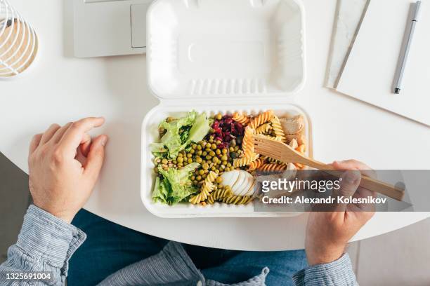 healthy pasta bowl in man's hands. delicious balanced food concept. delivery food, home office. - kazakhstan man stock pictures, royalty-free photos & images