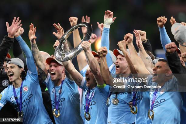 Scott Jamieson of Melbourne City celebrates victory with team mates and holds aloft the A-League trophy following the A-League Grand Final match...