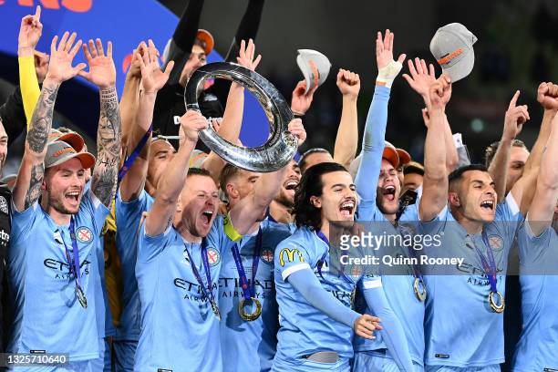 Scott Jamieson of Melbourne City holds up the trophy as Melbourne City celebrate winning the A-League Grand Final match between Melbourne City and...