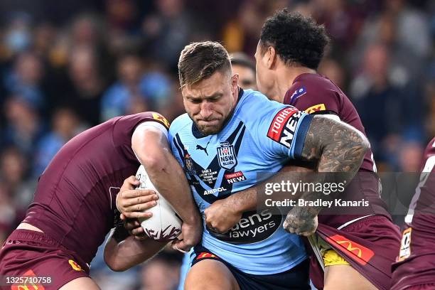 Tariq Sims of the Blues is tackled during game two of the 2021 State of Origin series between the Queensland Maroons and the New South Wales Blues at...