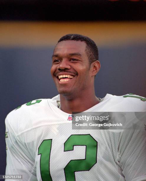 Quarterback Randall Cunningham of the Philadelphia Eagles smiles as he looks on from the sideline during a preseason game against the Pittsburgh...