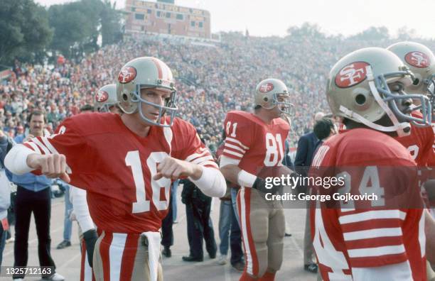 Quarterback Joe Montana of the San Francisco 49ers warms up prior to player introductions as tight end Russ Francis and running back Derrick Harmon...