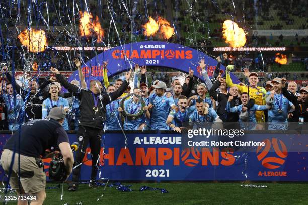 Scott Jamieson of Melbourne City celebrates victory with team mates and holds aloft the A-League trophy after winning the A-League Grand Final match...