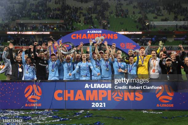 Scott Jamieson of Melbourne City celebrates victory with team mates and holds aloft the A-League trophy after winning the A-League Grand Final match...
