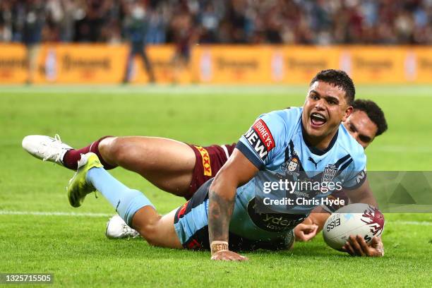 Latrell Mitchell of the Blues celebrates after scoring a try during game two of the 2021 State of Origin series between the Queensland Maroons and...