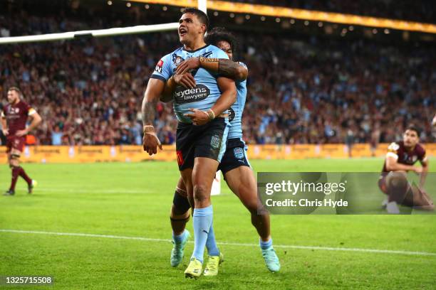 Latrell Mitchell of the Blues celebrates after scoring a try during game two of the 2021 State of Origin series between the Queensland Maroons and...