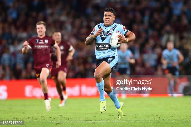 Latrell Mitchell of the Blues makes a break to score a try during game two of the 2021 State of Origin series between the Queensland Maroons and the...