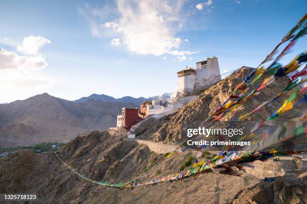 prayer flag in tsemo castle with beautiful mountain snow landscape background in leh ladakh - leh stock pictures, royalty-free photos & images