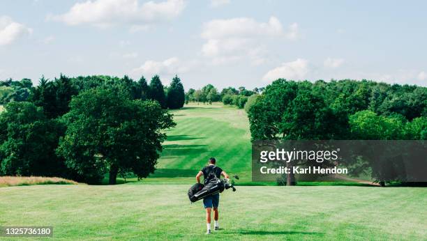 a daytime view of a golfer looking down a fairway - golf accessories stock pictures, royalty-free photos & images