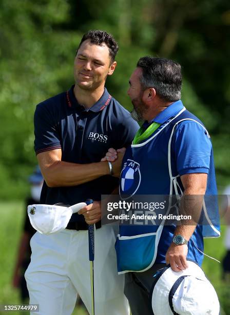 Martin Kaymer of Germany and his caddie Craig Connelly on the 18th green during the final round of The BMW International Open at Golfclub Munchen...