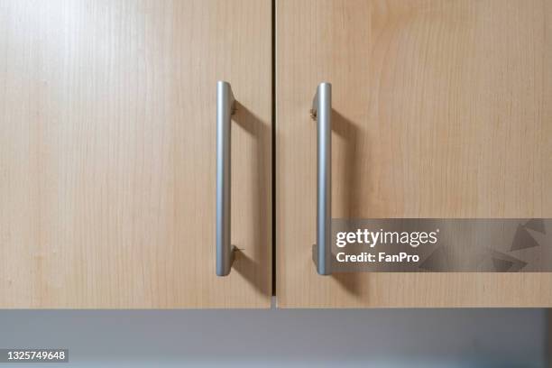wooden cabinet handle - handle stock pictures, royalty-free photos & images