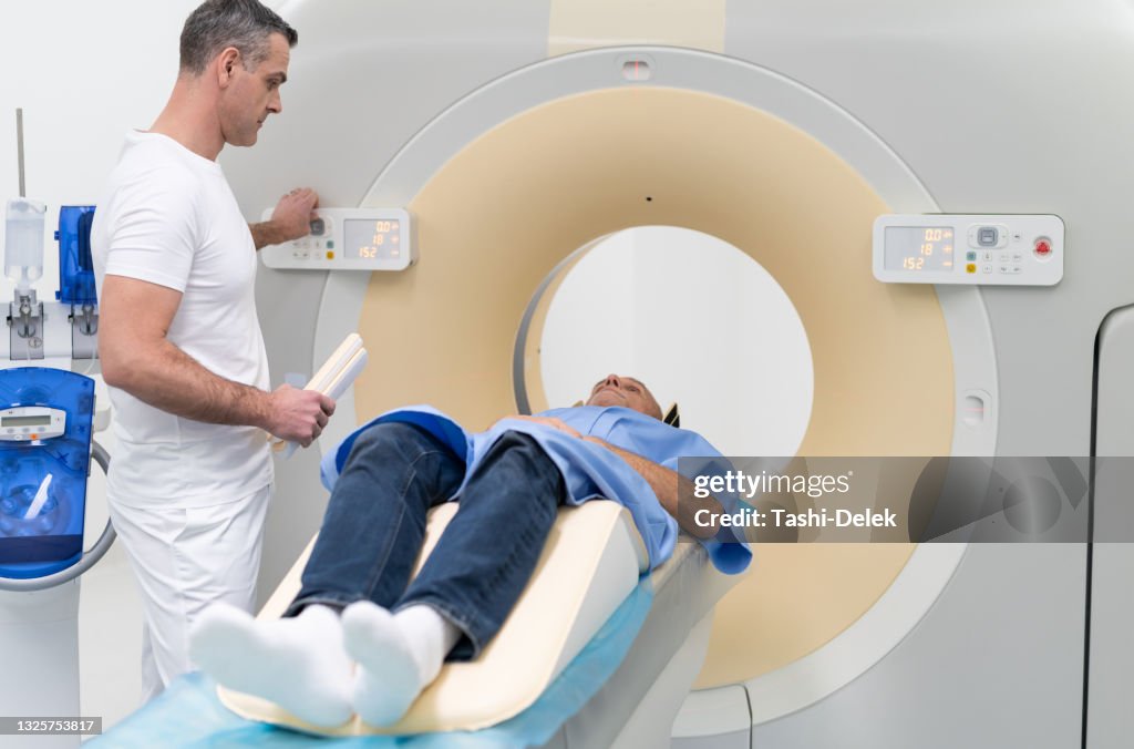 Mri Testing Process Doctor Explaining Mri Scan Procedure To Patient Laying On Mri Bed High ...