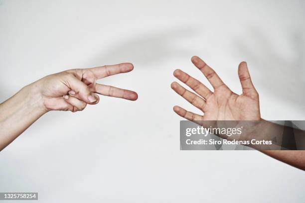 playing paper, scissors, stones, side view - forbici foto e immagini stock