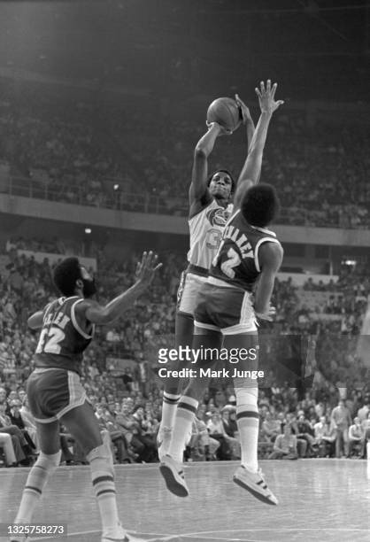 Denver Nuggets forward David Thompson aims a jump shot from near the free throw line toward the basket during an NBA basketball game against the Los...