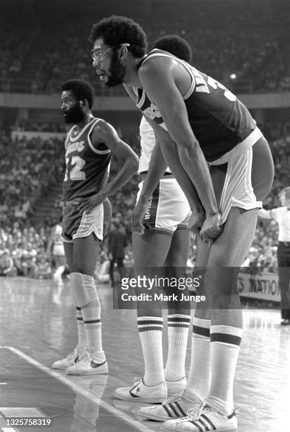 Los Angeles Lakers center Kareem Abdul-Jabbar and guard Lucius Allen wait along the lane for a rebound during a free throw by a Denver Nuggets player...
