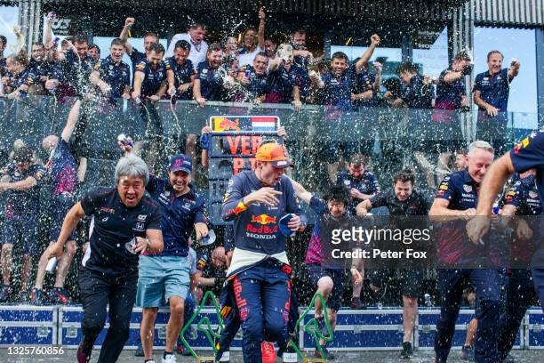 Max Verstappen of Red Bull Racing and The Netherlands and Sergio Perez of Mexico and Red Bull Racing celebrate victory with the team during the F1...