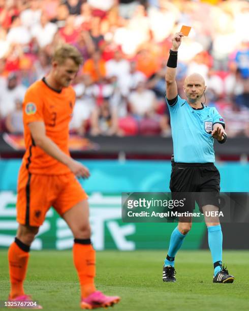 Match Referee, Sergei Karasev shows a red card to Matthijs de Ligt of Netherlands after a VAR review during the UEFA Euro 2020 Championship Round of...