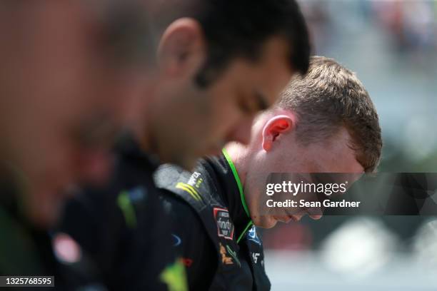 Riley Herbst, driver of the Monster Energy Ford, bows his head during pre-race ceremonies ob the grid prior to the NASCAR Xfinity Series Pocono Green...