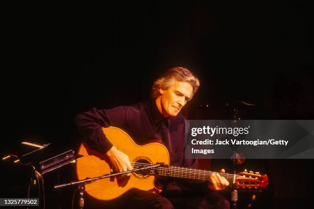 English Jazz and Fusion musician, composer, and band leader John McLaughlin plays acoustic guitar as he performs onstage at Avery Fisher Hall at...