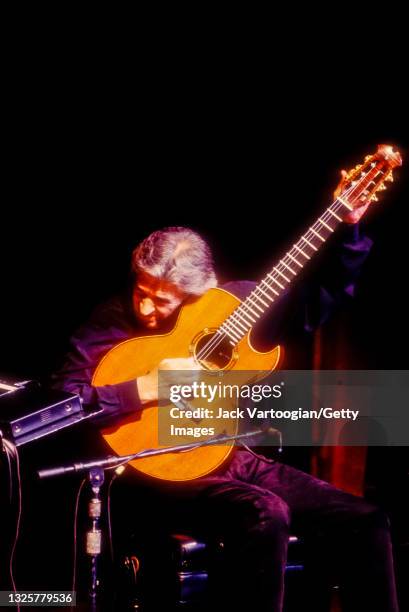 English Jazz and Fusion musician, composer, and band leader John McLaughlin plays acoustic guitar as he performs onstage at Avery Fisher Hall at...