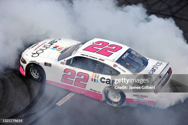 Austin Cindric, driver of the Car Shop Ford, celebrates with a burnout after winning the NASCAR Xfinity Series Pocono Green 225 Recycled by J.P....