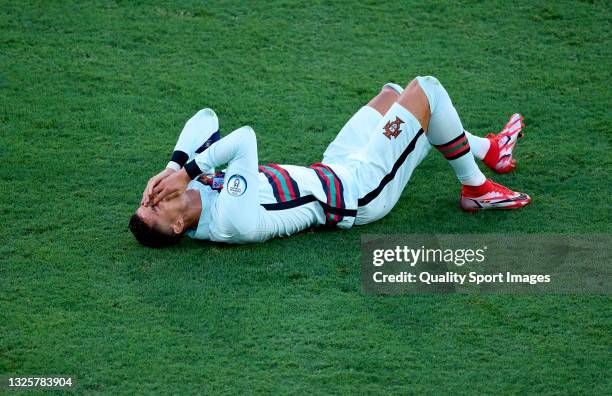 Cristiano Ronaldo of Portugal lies injured on the pitch during the UEFA Euro 2020 Championship Round of 16 match between Belgium and Portugal at...