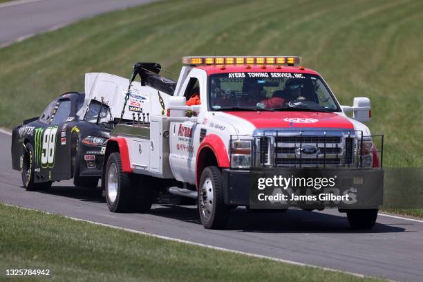 The Monster Energy Ford, driven by Riley Herbst is towed off the track during the NASCAR Xfinity Series Pocono Green 225 Recycled by J.P. Mascaro &...