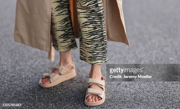 Elise Soho wearing Ganni pants, beige Ducie London sandals and beige Soho Studios trenchcoat on June 26, 2021 in Hamburg, Germany.