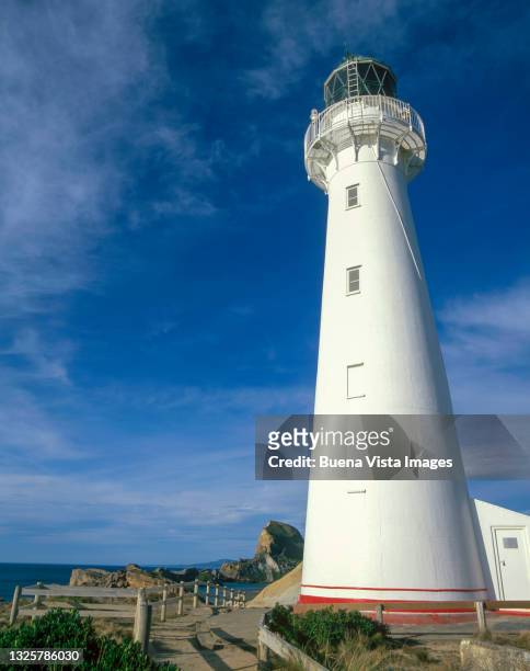 white lighthouse over a hill - cape egmont lighthouse stock pictures, royalty-free photos & images
