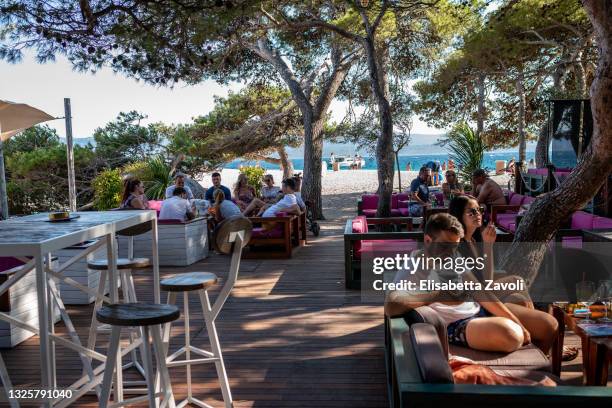 Tourists enjoy a drink at the Auro Bar on Zlatni Rat beach on June 27, 2021 in Bol, Croatia. Croatia has already reported a 40 percent increase in...