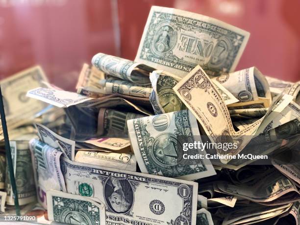 glass donation box with paper currency & coins - us paper currency stock pictures, royalty-free photos & images