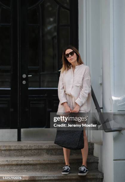 Elise Soho wearing black low Vans sneakers, black beach bag and beige Soho Studios two piece on June 26, 2021 in Hamburg, Germany.