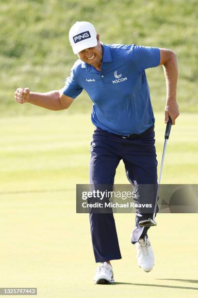 Harris English of the United States reacts to his birdie putt on the 18th green during the final round of the Travelers Championship at TPC River...