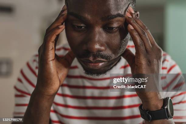 young guy has a stressful day and headache - struggle stock pictures, royalty-free photos & images