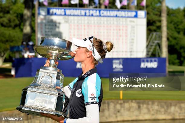 Nelly Korda poses with the trophy after putting in to win on the 18th green during the final round of the KPMG Women's PGA Championship at Atlanta...