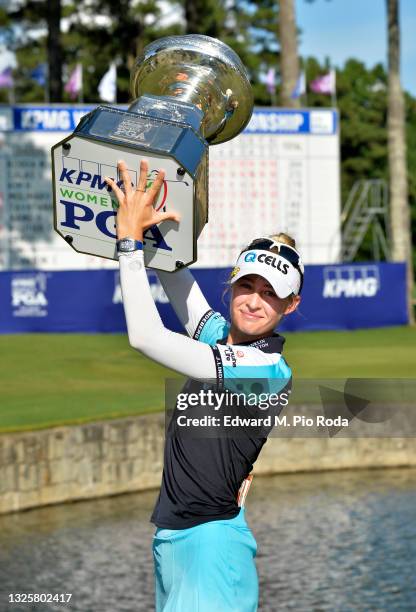 Nelly Korda poses with the trophy after putting in to win on the 18th green during the final round of the KPMG Women's PGA Championship at Atlanta...